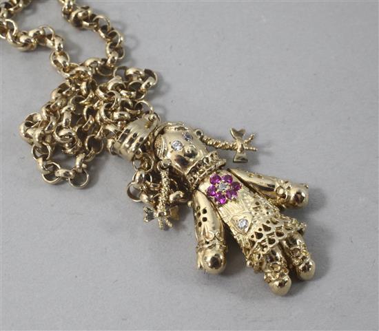 A 9ct gold gem set doll pendant on a 9ct gold chain, pendant 38mm.